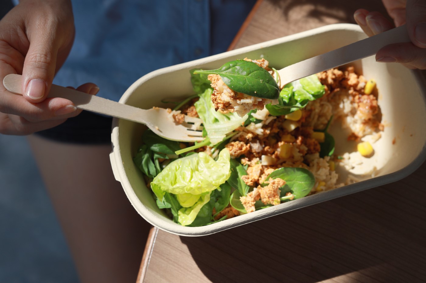 Woman Having A Healthy Vegan Lunch Break From Delivered Eco Lunch Boxes. Delicious Balanced Food Concept. Eco Zero Waste Tableware. Food Delivery